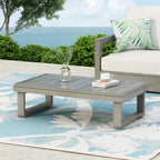 Table basse d'extérieur en bois d'acacia avec plateau à lattes et pieds patins